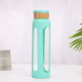 Umweltfreundliche BPA-freie Sportglasflaschen-Silikonhülle mit Bambusdeckel